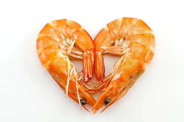 Boiled shrimp isolated on white with heart shape