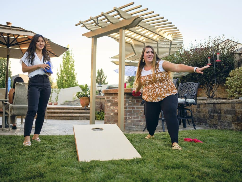 Backyard Party Playing Cornhole Bean Bag Toss Game