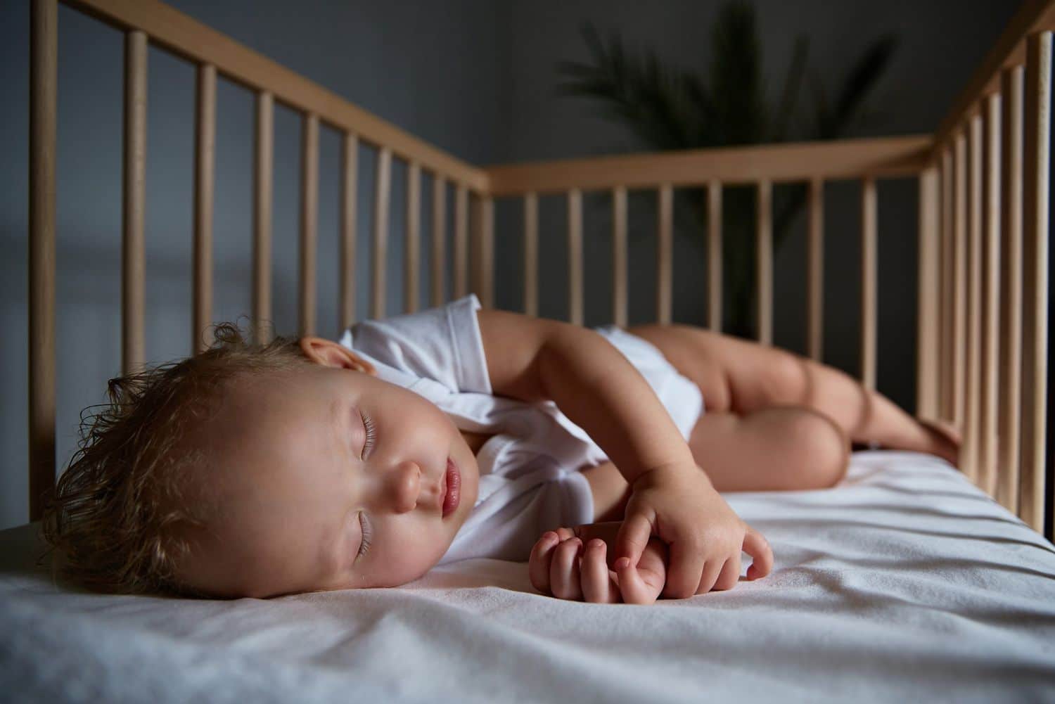 A peacefully sleeping baby in a crib, surrounded by a serene and ideal sleeping environment