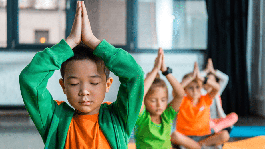 Children doing yoga in a classroom: Home Exercises for Fitness