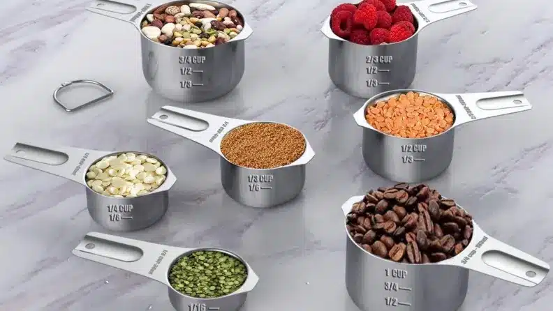  A set of measuring cups with various nuts and seeds