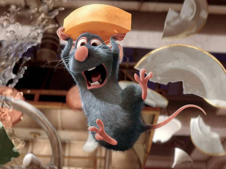 A cartoon mouse from 'Ratatouille' holds a cheese slice, showcasing the iconic scene in the film