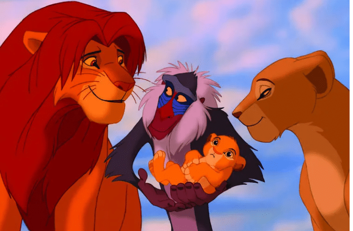 the Lion King, stands proudly with his adorable cubs by his side. A majestic family portrait.