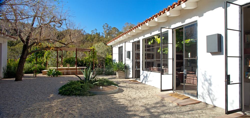 A serene courtyard at The Ranch Malibu in Malibu, California, featuring a charming patio and a welcoming door.