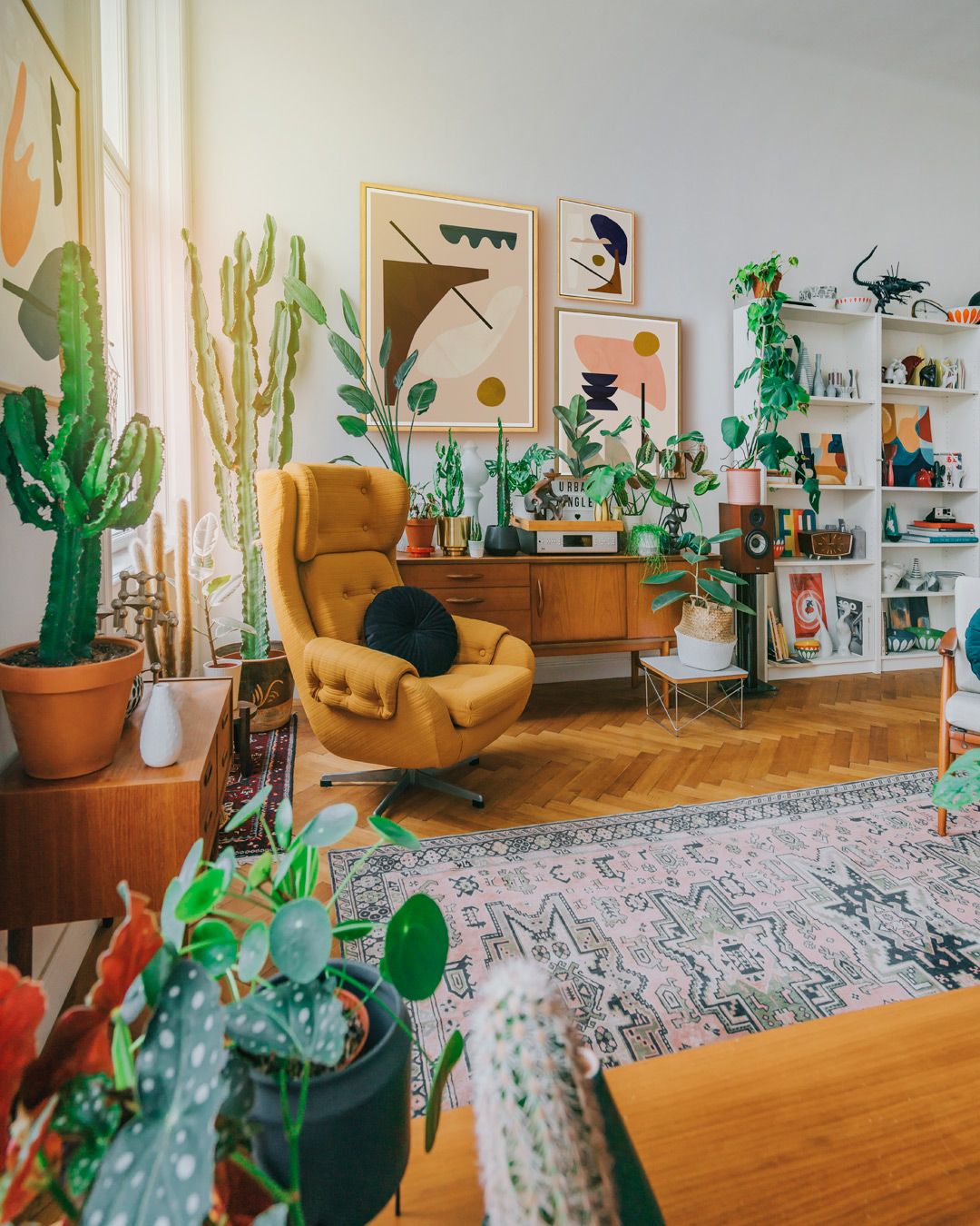 A well-decorated living room filled with lush plants and stylish furniture