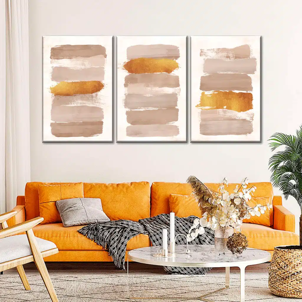 Three paintings with orange and brown paint on the wall. A vibrant display of colors from the Ultimate Color Palette Selection