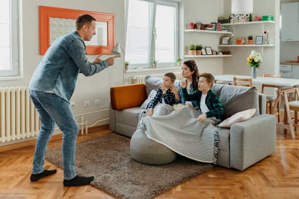 Young Parents and Their Children Are Having Fun and Playing Charades Together. Portrait of Happy Family of Four Having Fun at Leisure. Entertainment Concept.