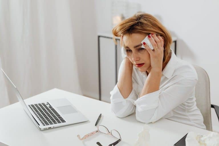 Free Woman Sitting at a Table Crying Stock Photo