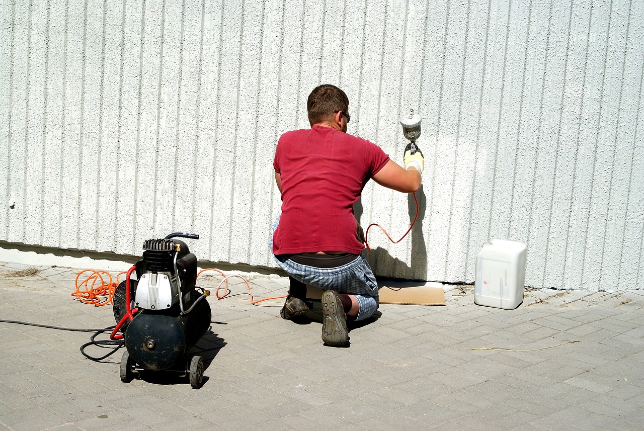 A man doing painting on the wall