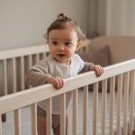 toddler climbing out of crib